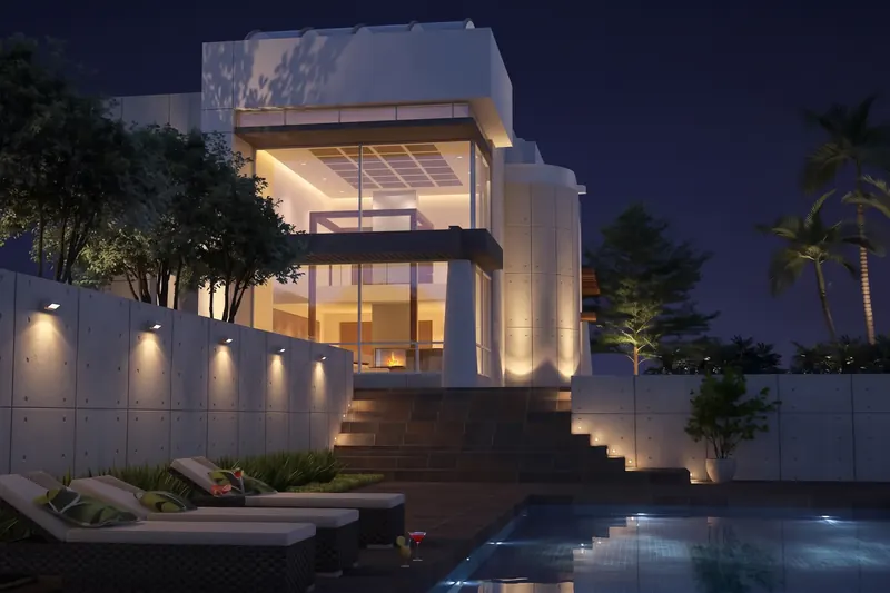 Modern white home at night with a two-story glass facade, fireplace glow, lit concrete walls, stairs and poolside loungers