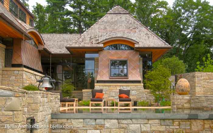 Copper clad contemporary cottage with stone terraces