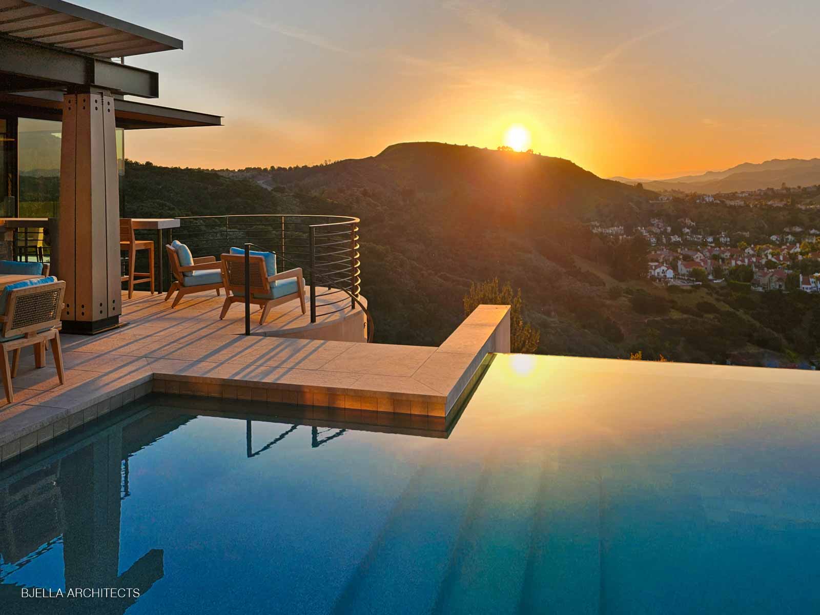 Infinity pool at sunset overlooking the hills