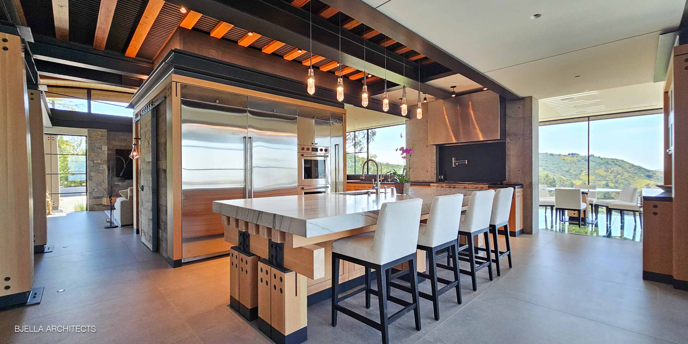 The island and cabinetry open to the valley beyond