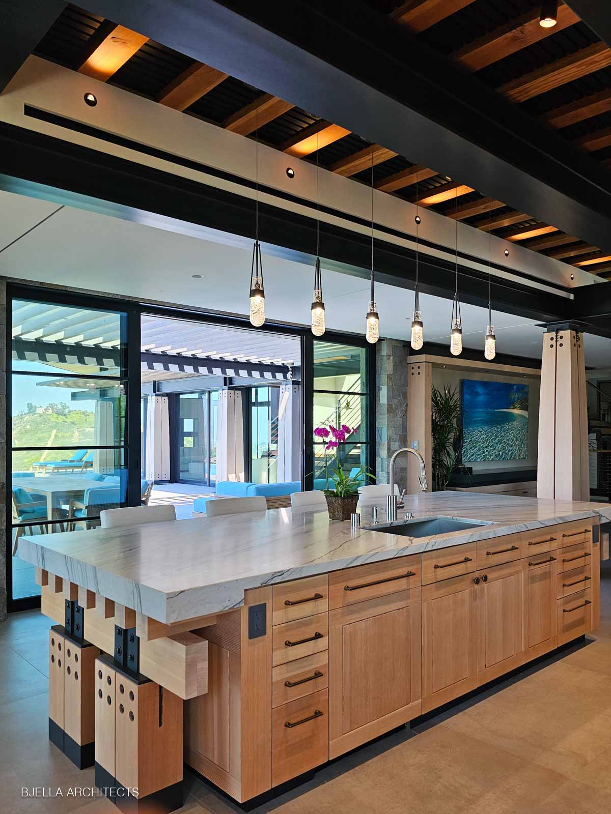 The island under its pendants, windows to the terrace