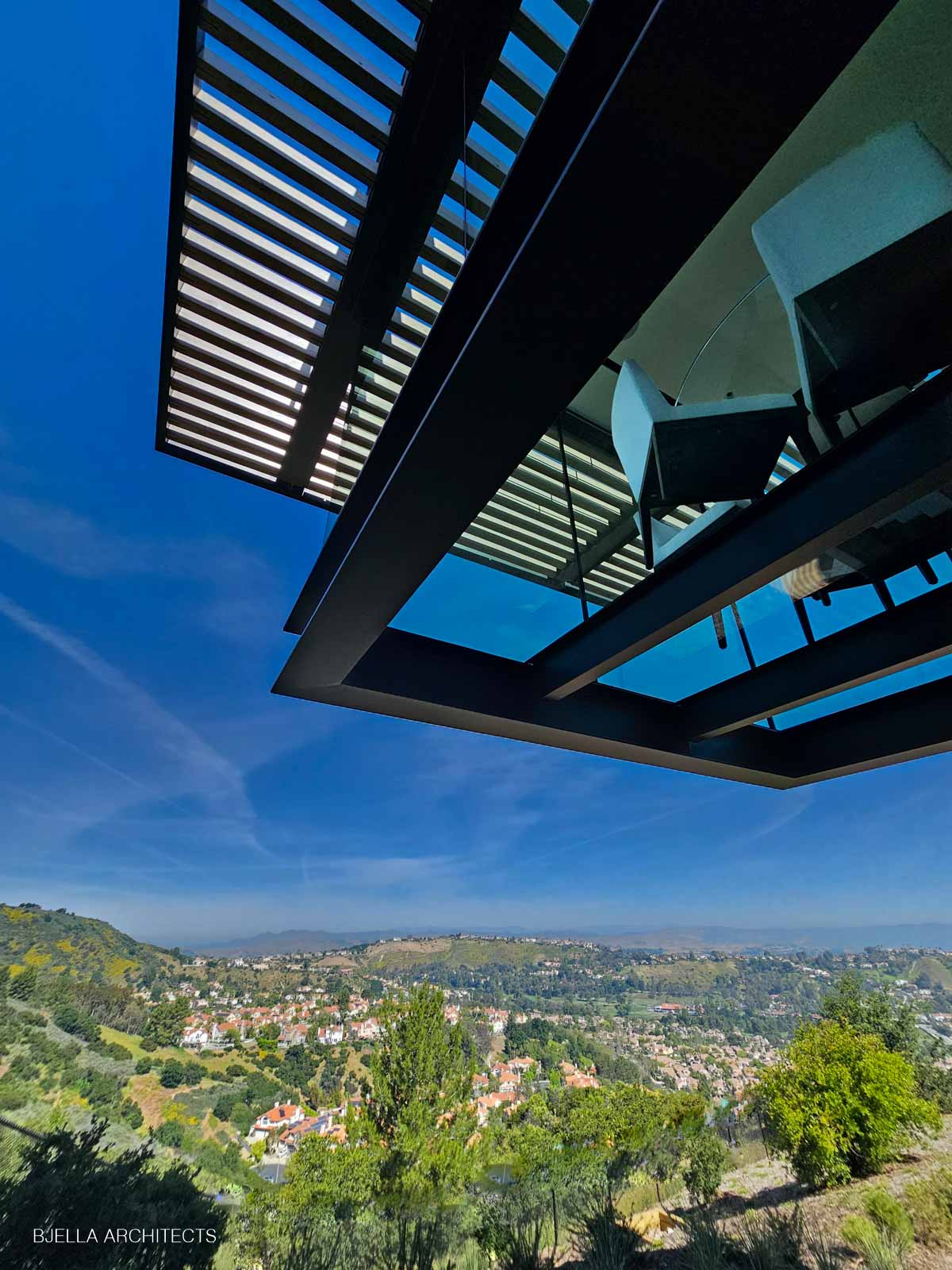 The rooftop trellis casting shade over the valley view