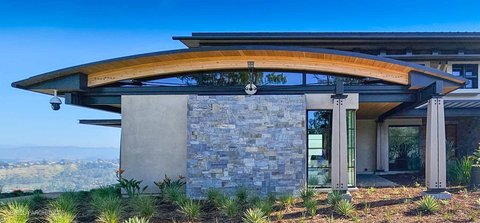 The front elevation in timber, stone and glass