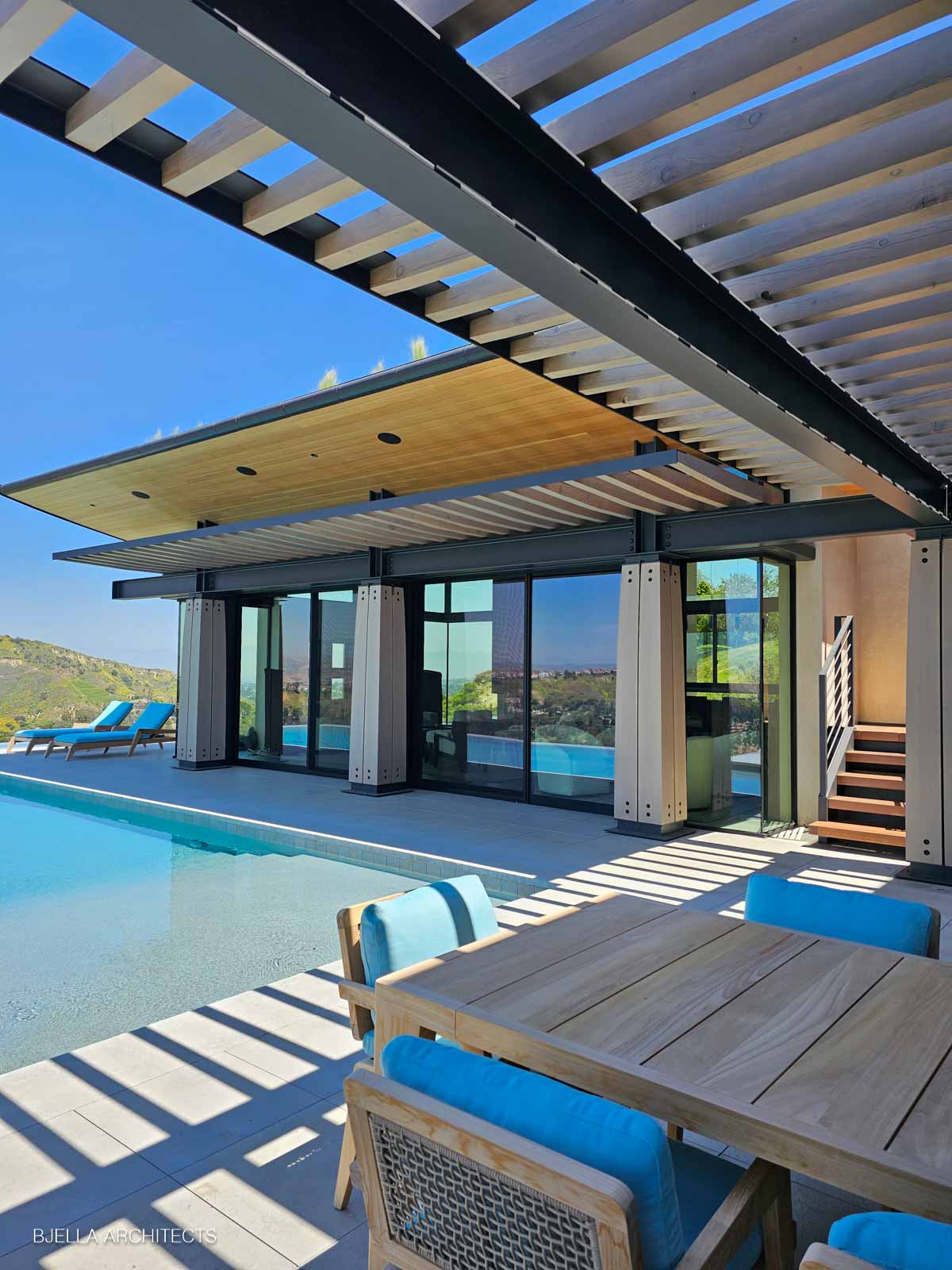 The pool terrace beneath the timber pergola