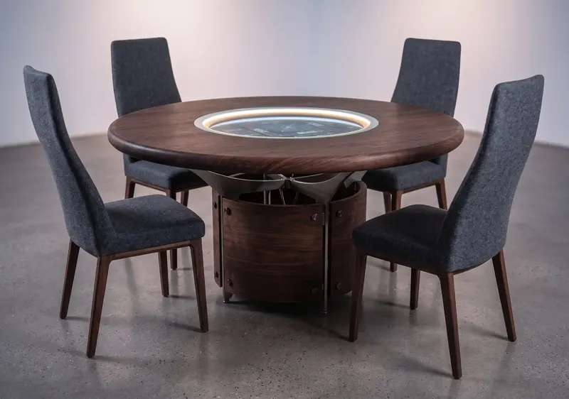 Bespoke round dark wood table with a glass-covered screen ringed in light at its center, steel supports and four grey chairs