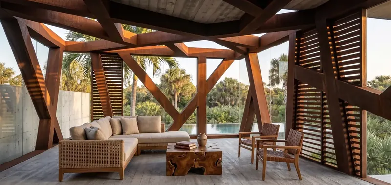 Lounge under exposed weathering steel framing and slatted screens, woven sofa, root-wood table and leather chairs, pool beyond