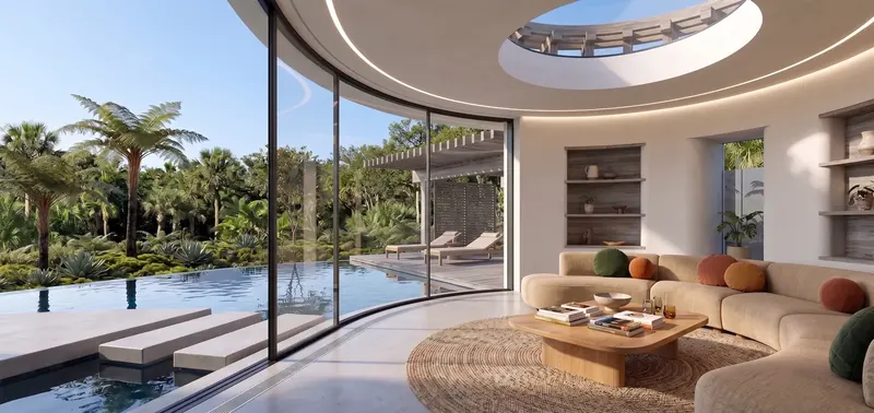 Guest house living room with curved glass wall, round skylight, sectional sofa and stepping stones over the pool
