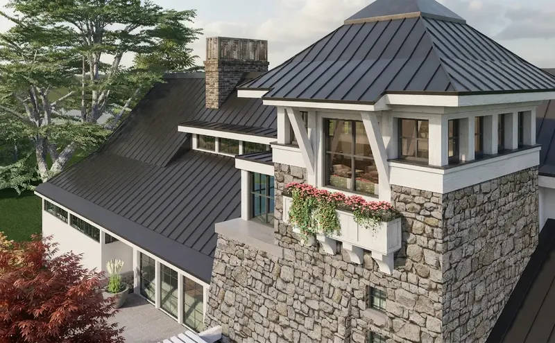 Elevated view of the tower's standing-seam metal roof, white brackets and flowering window box, with a chimney behind