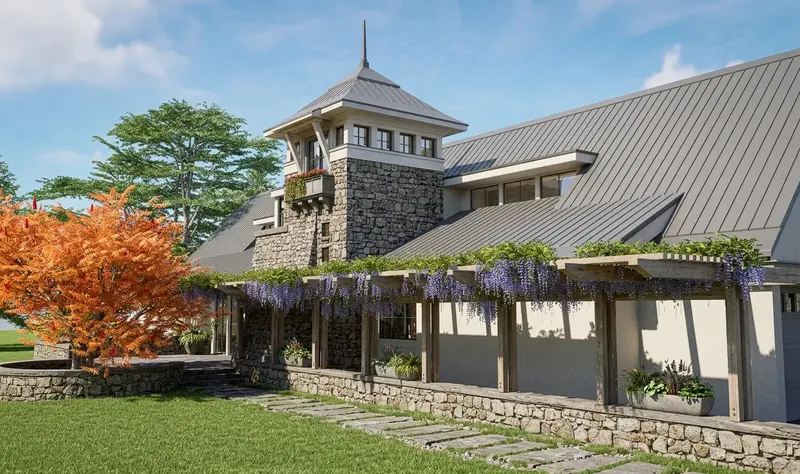 Wisteria-draped pergola on a low stone wall, with the stone tower rising behind and an orange-leaved tree at left