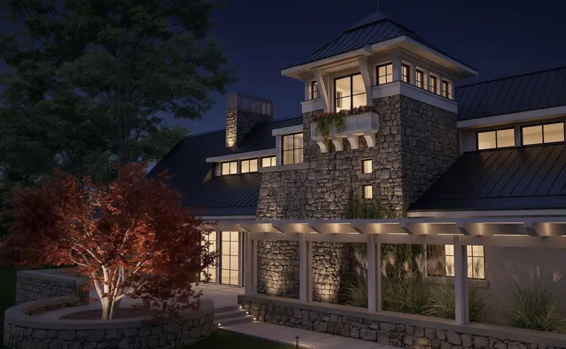 Lakeside Tower Home at night, its stone tower and window box lit above a white pergola and a curved stone planter