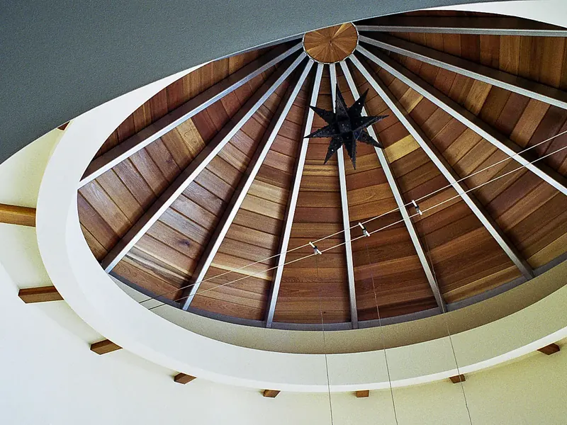 Vaulted wood-paneled dinette ceiling radiating from a black star pendant