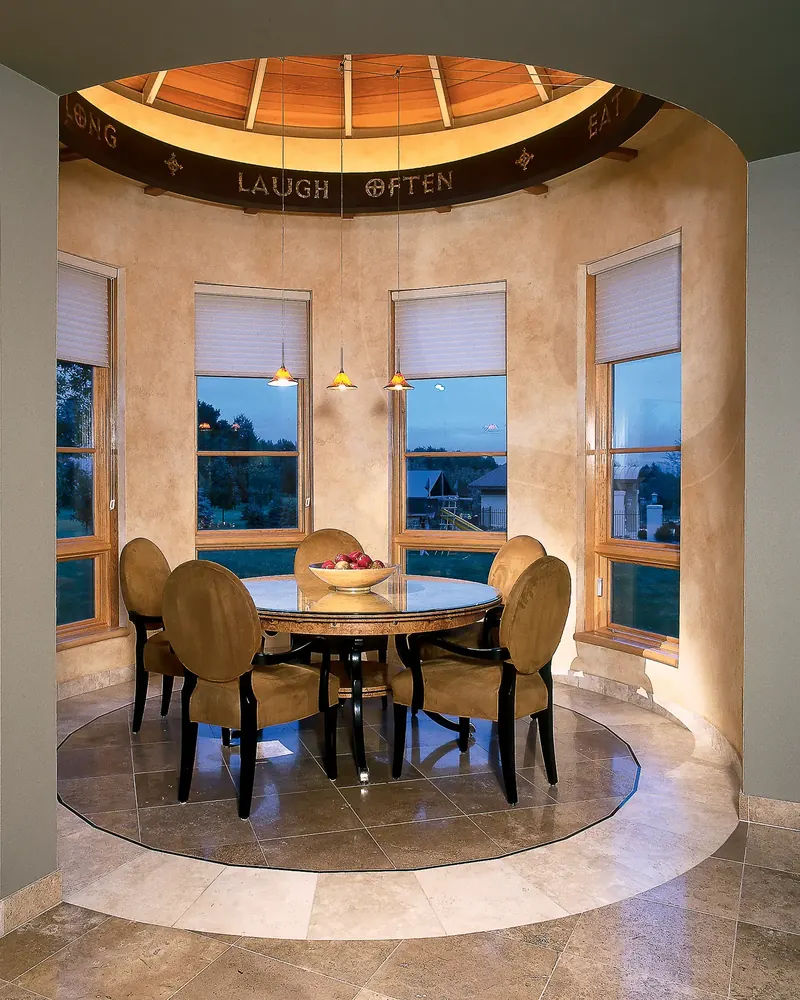 Circular formal dining room with an inscribed soffit and panoramic windows