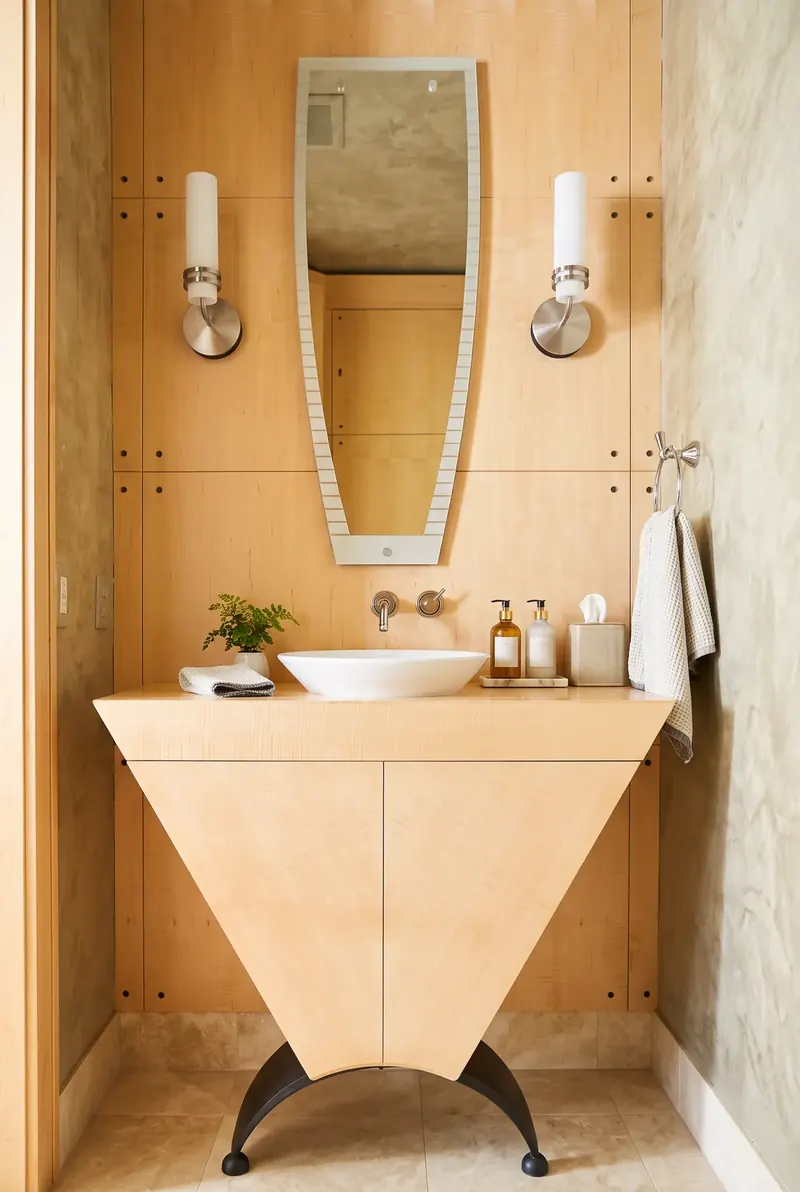 Powder room with a tapered maple vanity and a white vessel sink