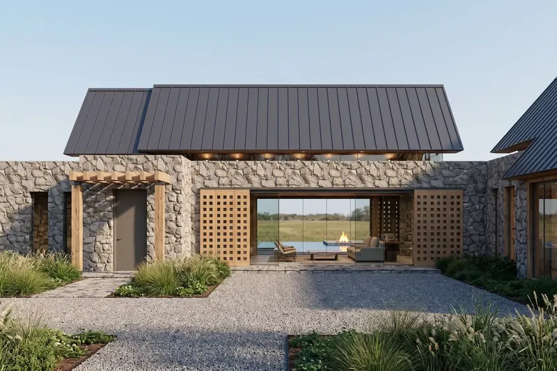 Stone wall with gridded wooden barn doors slid open to a glass living room looking through to the pool and prairie