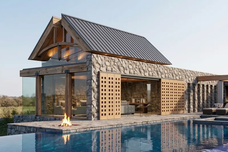 Stone pavilion with gridded barn doors open to a study and lounge, a fire pit on the patio reflected in the pool
