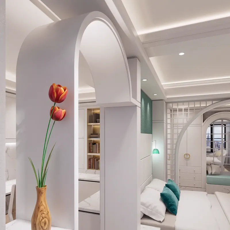 Thick white archway with red tulips in a wood vase, opening to a bedroom with teal accents and lattice screens