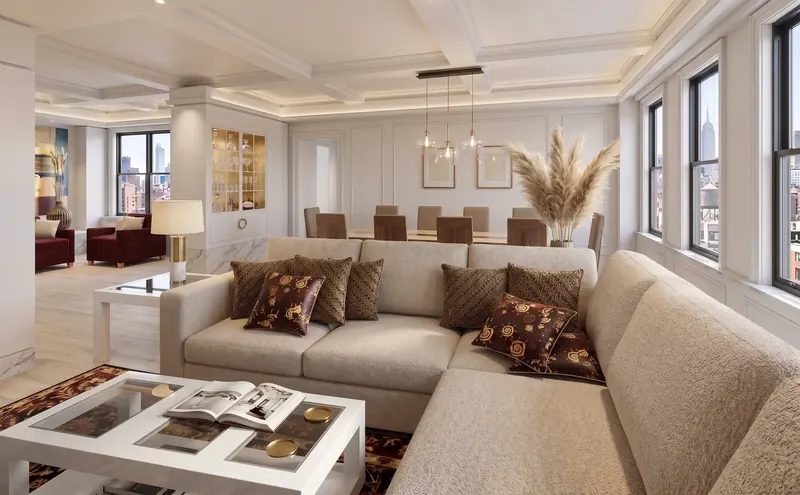 Living room of the Modern Fairytale Apartment, a sectional under a coffered ceiling, dining table beyond, Empire State Building in the window