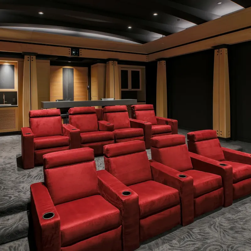 Tiered red recliners in the theater, timber columns and a curved dark ceiling above