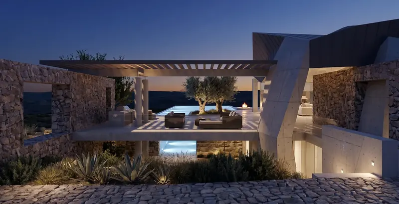 The Monolith Retreat at dusk, a lit pergola terrace with olive trees, fire pit and pool between stone and concrete walls
