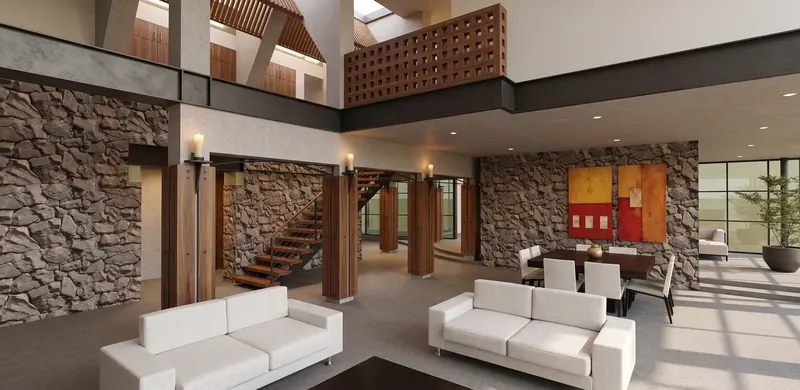 Double-height living and dining space under a wooden lattice balcony, with stone walls and candle-topped columns