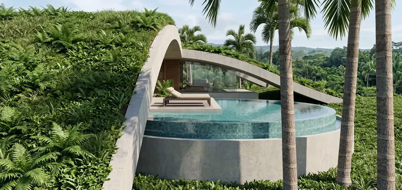 Circular tiled plunge pool and sun lounger nestled under a fern-covered concrete arch, with jungle hills beyond