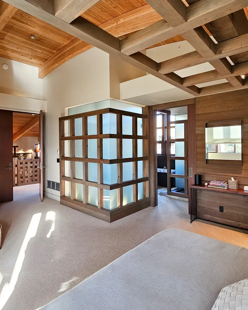 Bedroom with a timber-framed frosted glass enclosure under exposed ceiling beams