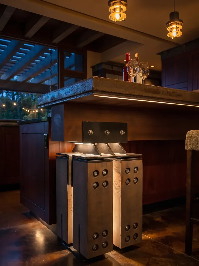 Bar counter on its steel-wrapped timber support under pendant lights at night