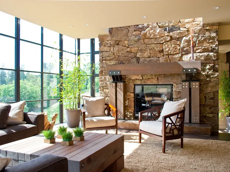Living room seating around a timber coffee table before a stone fireplace
