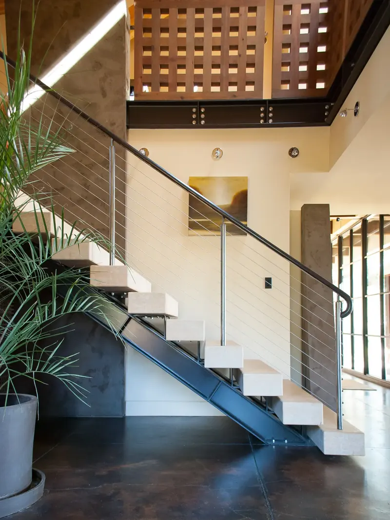 Side view of the floating stair and steel stringer below a timber screen