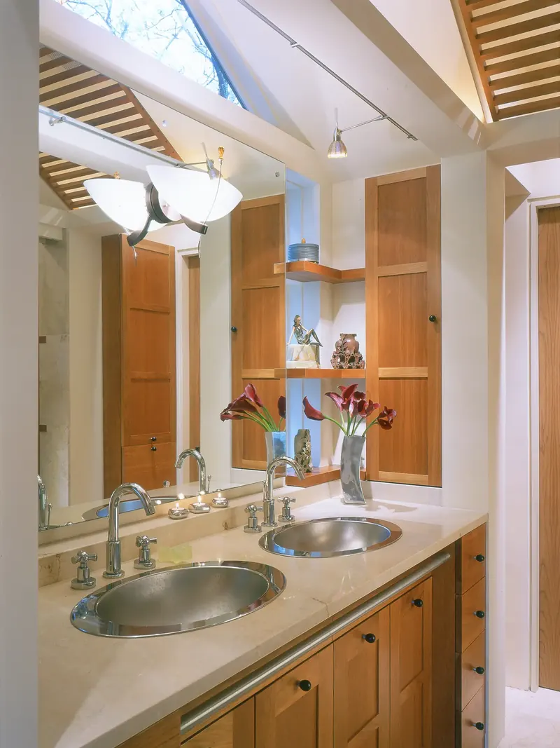 Double vanity with steel bowl sinks and wood cabinets under a slatted trellis skylight, Seattle