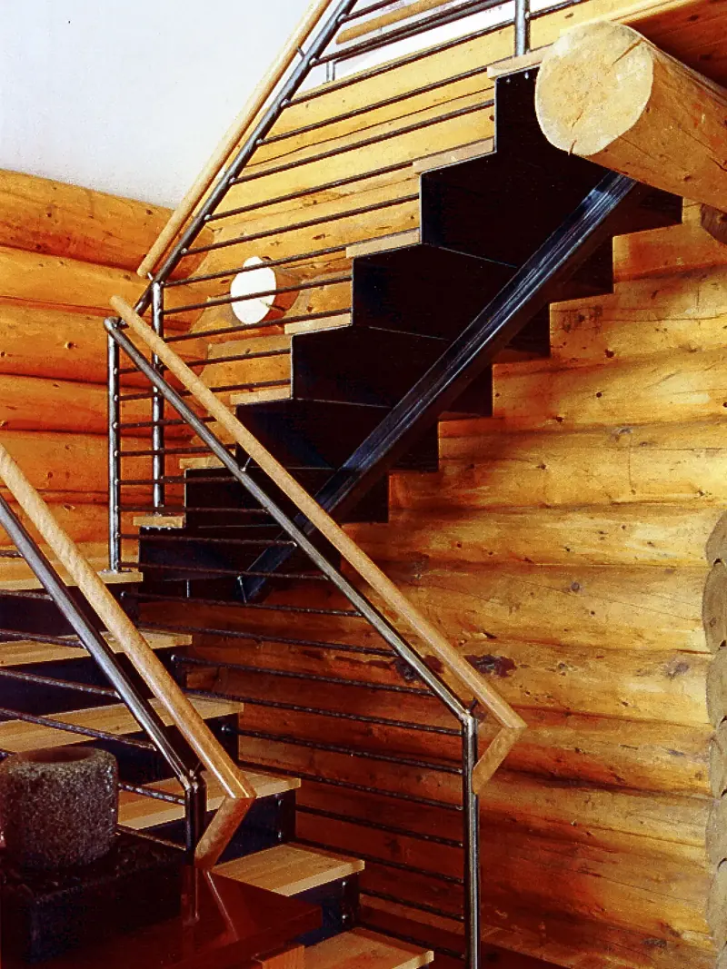 Steel stair with wood treads and metal railing against log walls, Boulder, Colorado