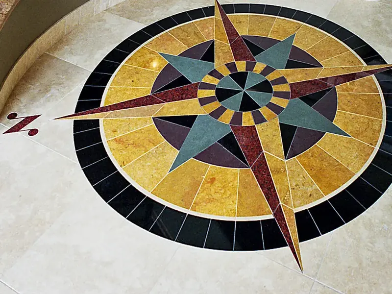 Compass-star stone medallion inlaid in a foyer floor