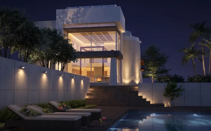 Beach home at night, glass bay lit and wall lights washing the steps down to the pool