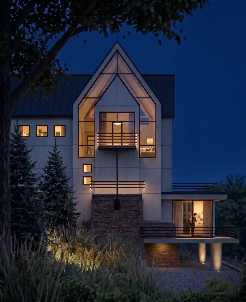 Stucco and brick house at night, the glazed gable and lower terrace room lit from within, Virginia