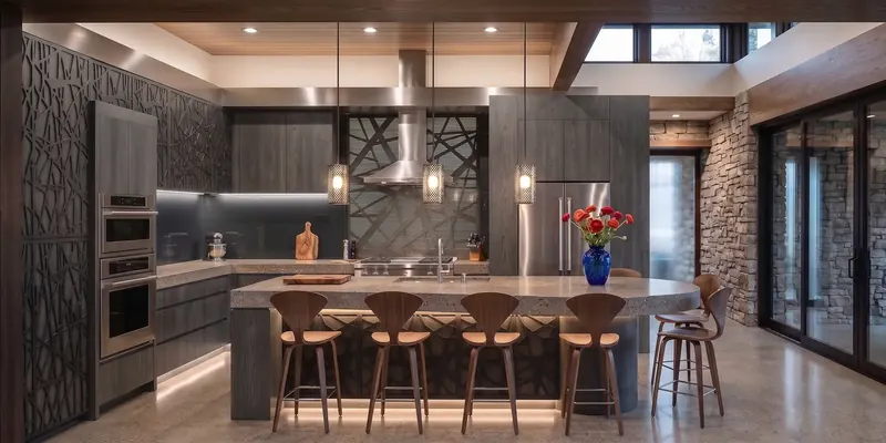 Dark kitchen with patterned cut-out panels, a stainless hood and wood stools at a stone island
